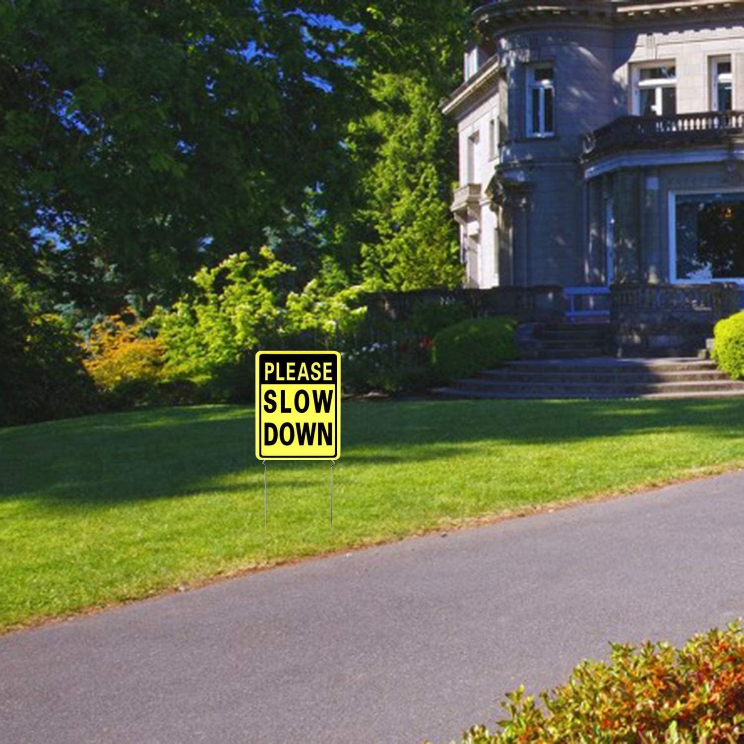 Kichwit Slow Down Yard Signs installed in yard with metal stakes