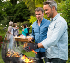 Kitchen Perfection BBQ Gloves in use while grilling on a gas grill