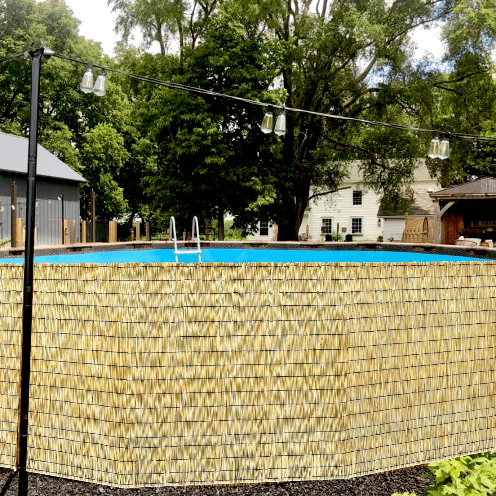 KOIUEYW Bamboo Reed Fencing installed in a garden setting