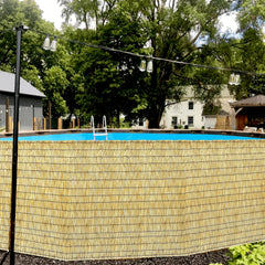 KOIUEYW Bamboo Reed Fencing installed in a garden setting