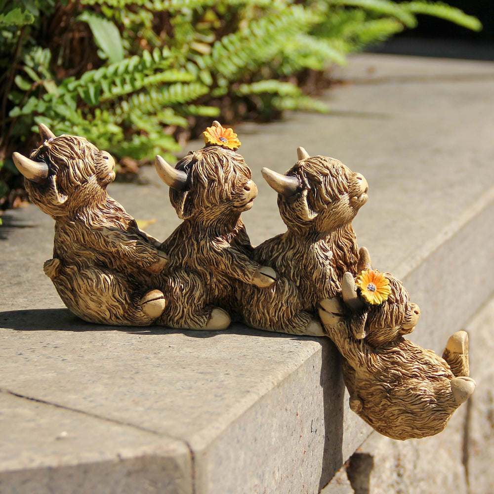 Leekung Highland Cow Figurine with surrounding garden decor