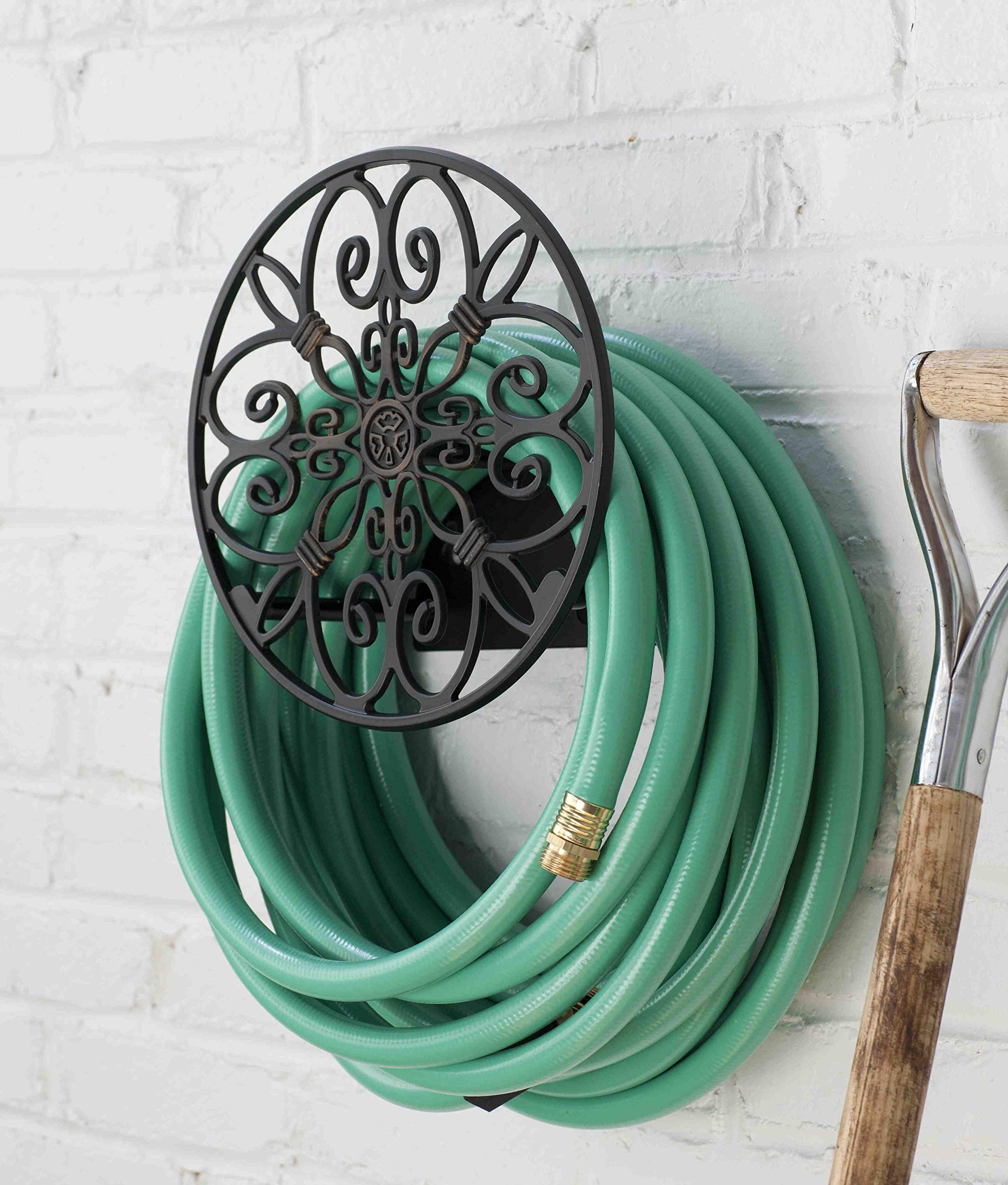 Liberty Garden Hose Butler mounted on wall with garden hose