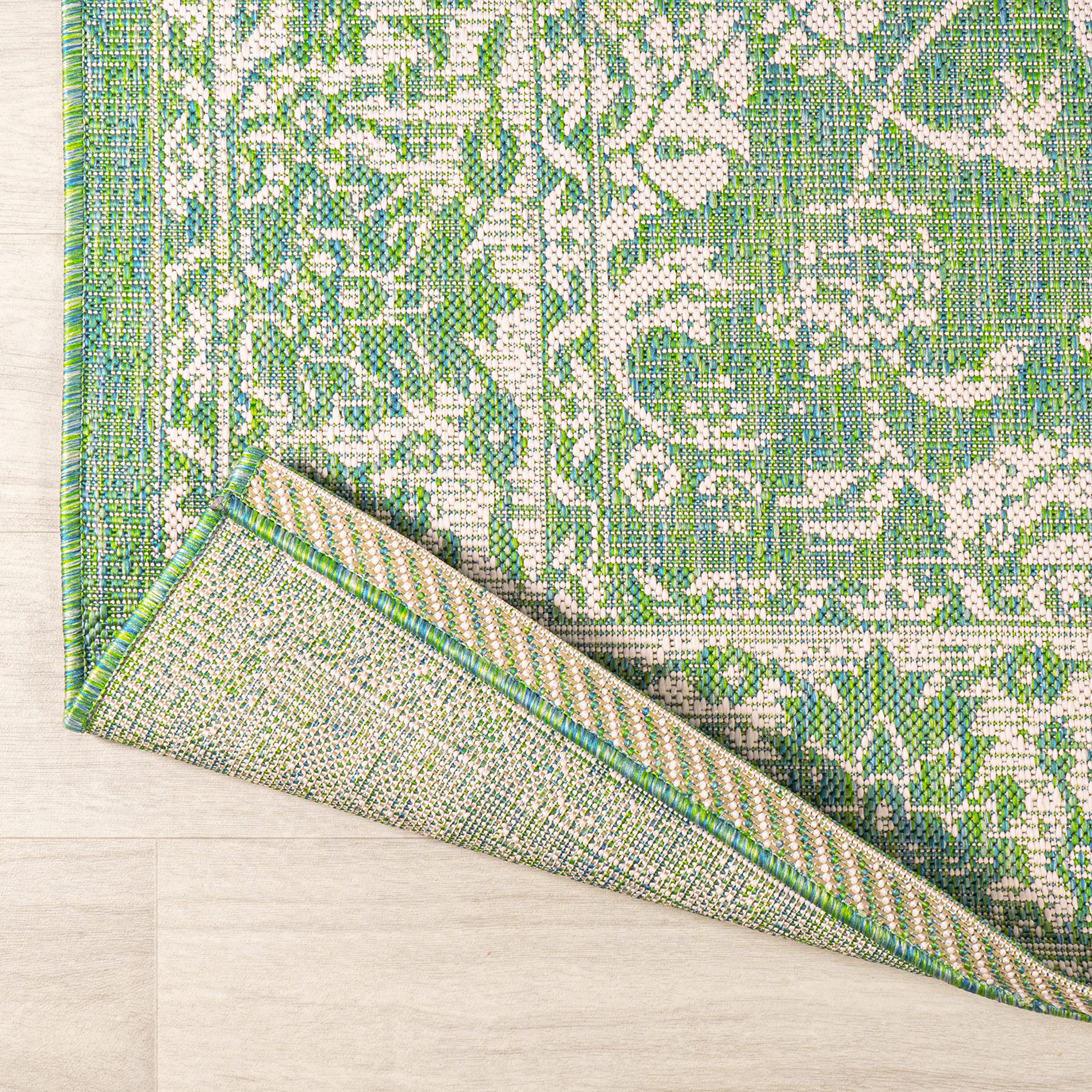 Lifestyle image of JONATHAN Y Weave Floral Runner Rug in a garden setting