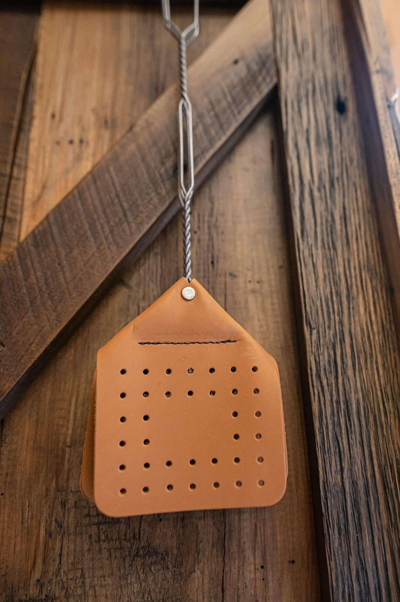 Lifestyle image of using Hope Woodworking fly swatter in a garden