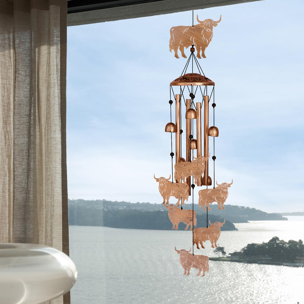 Lifestyle scene of Highland Cow Wind Chimes in patio setting