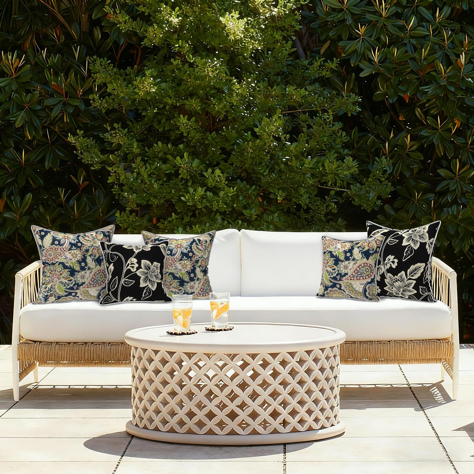 Lifestyle scene of LVTXIII Outdoor Throw Pillow Covers on patio furniture