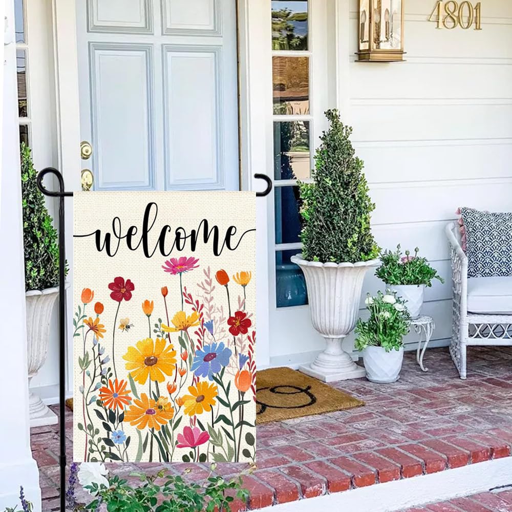 Lifestyle scene with ARGOOFG garden flag in a blooming garden