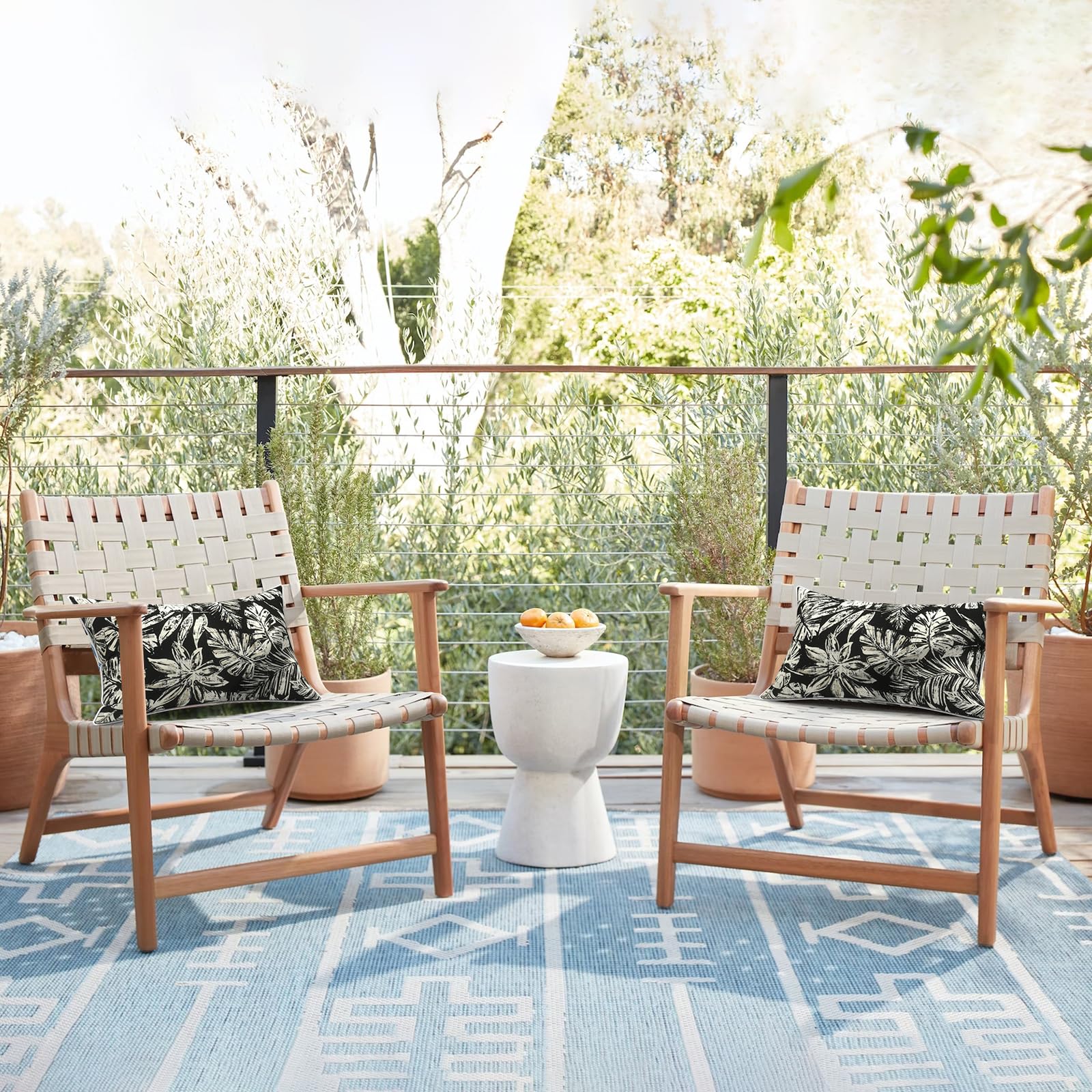 Lifestyle scene with LVTXIII outdoor lumbar pillow covers on garden sofa