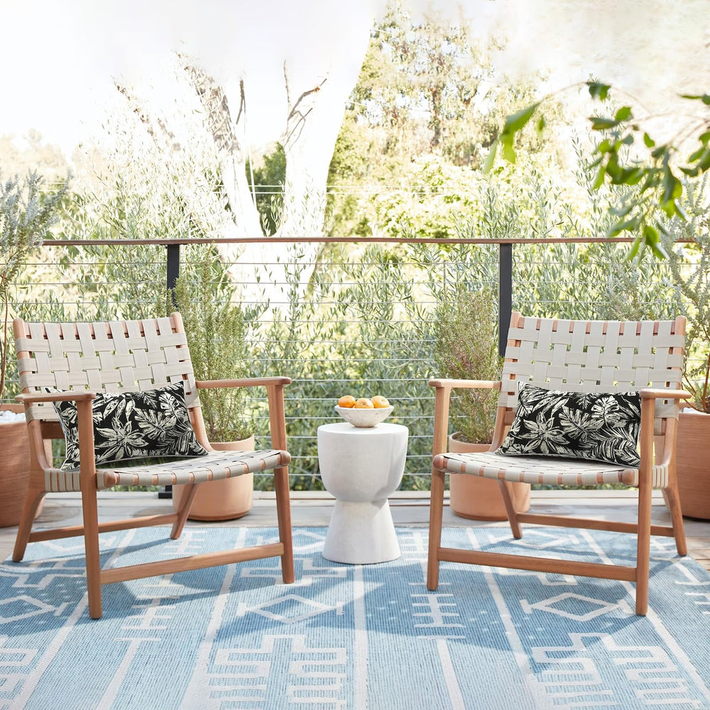 Lifestyle scene with LVTXIII outdoor lumbar pillow covers on garden sofa