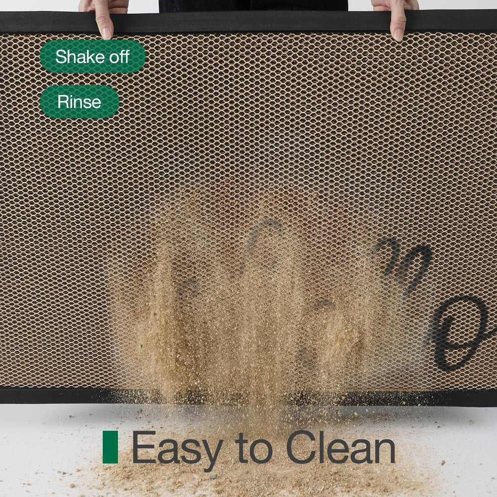 LUMI Welcome Door Mat being rinsed with a hose