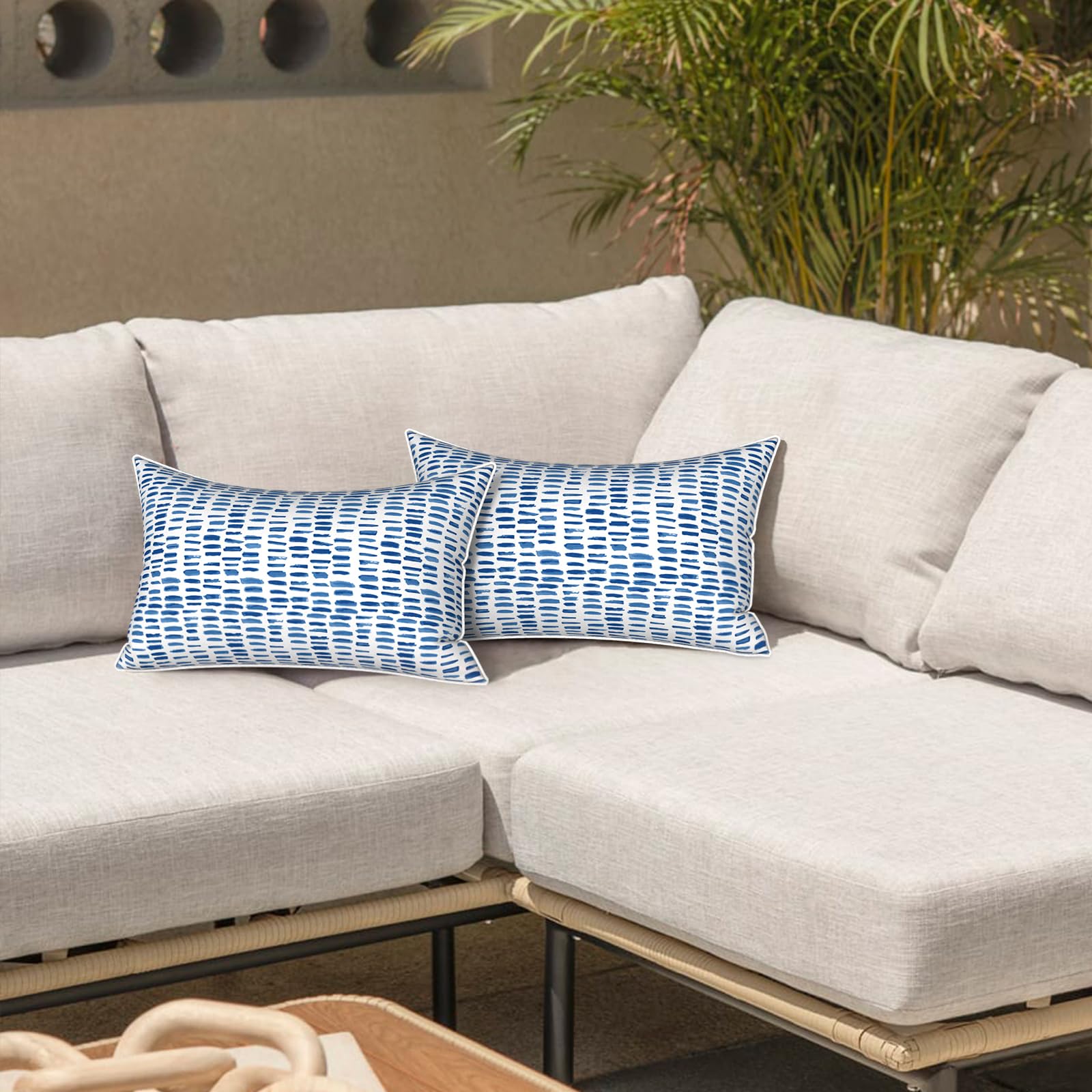 LVTXIII Outdoor Lumbar Pillow Cover in A Pebble Blue on a garden bench