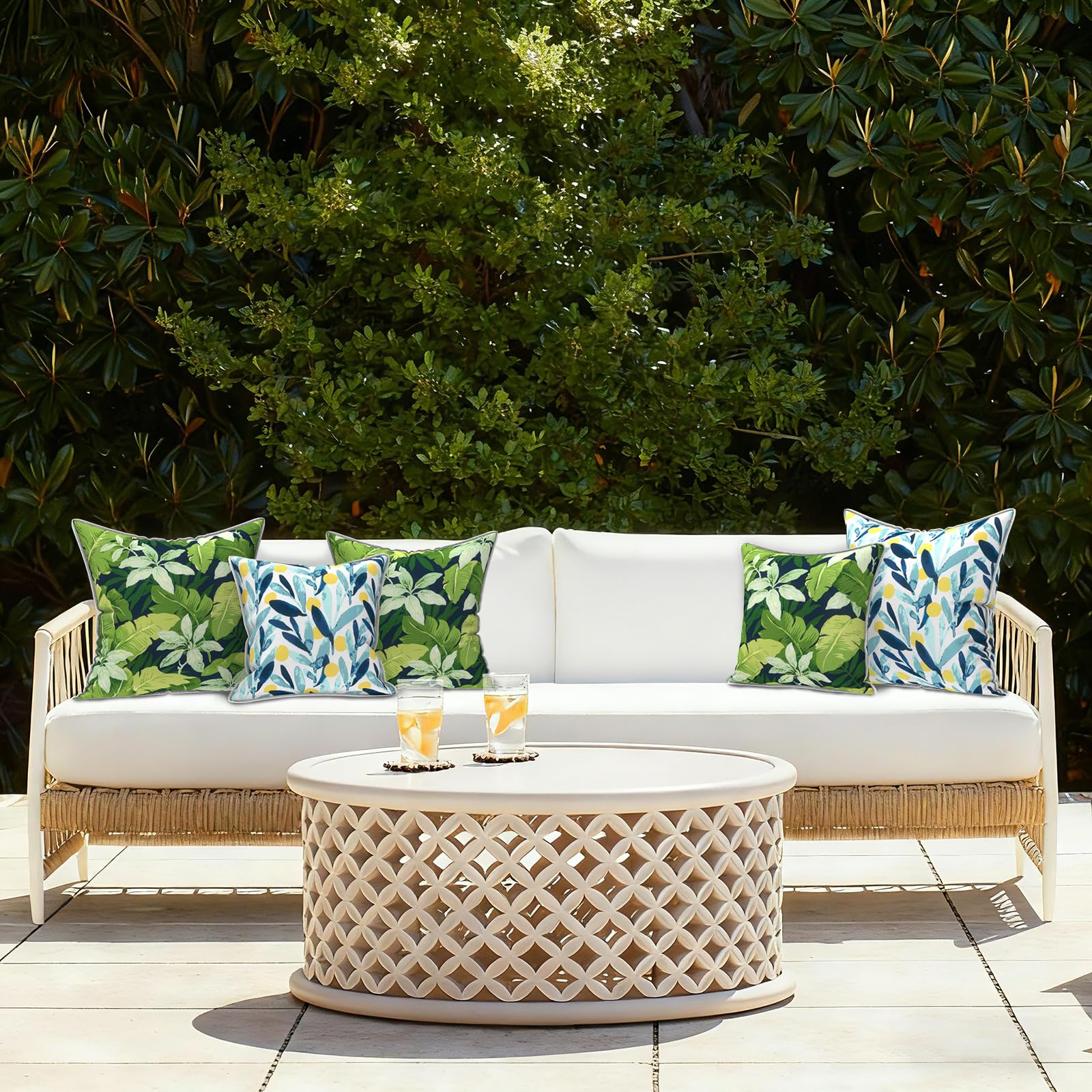 LVTXIII Outdoor Throw Pillows displayed in a garden setting