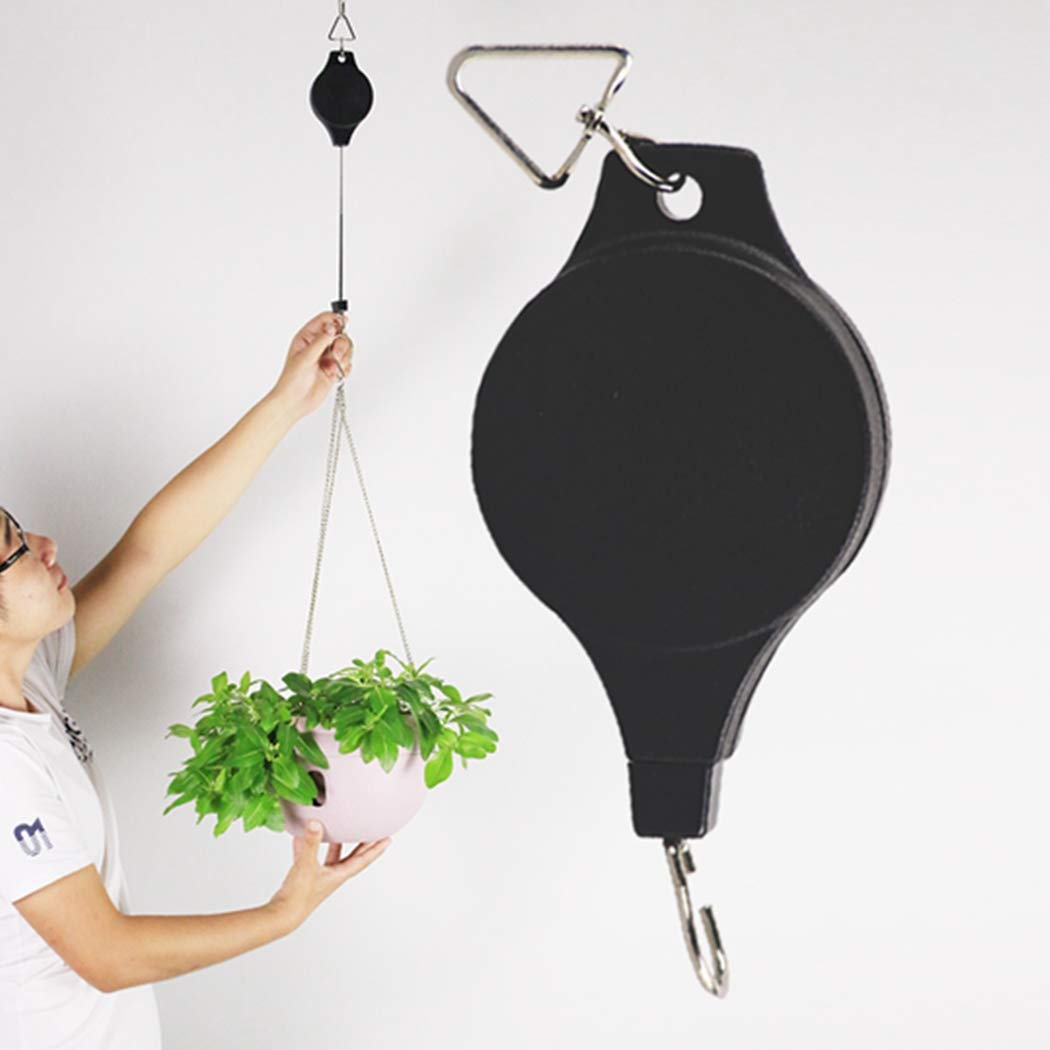 Lythor plant hanger in garden setting with flowers