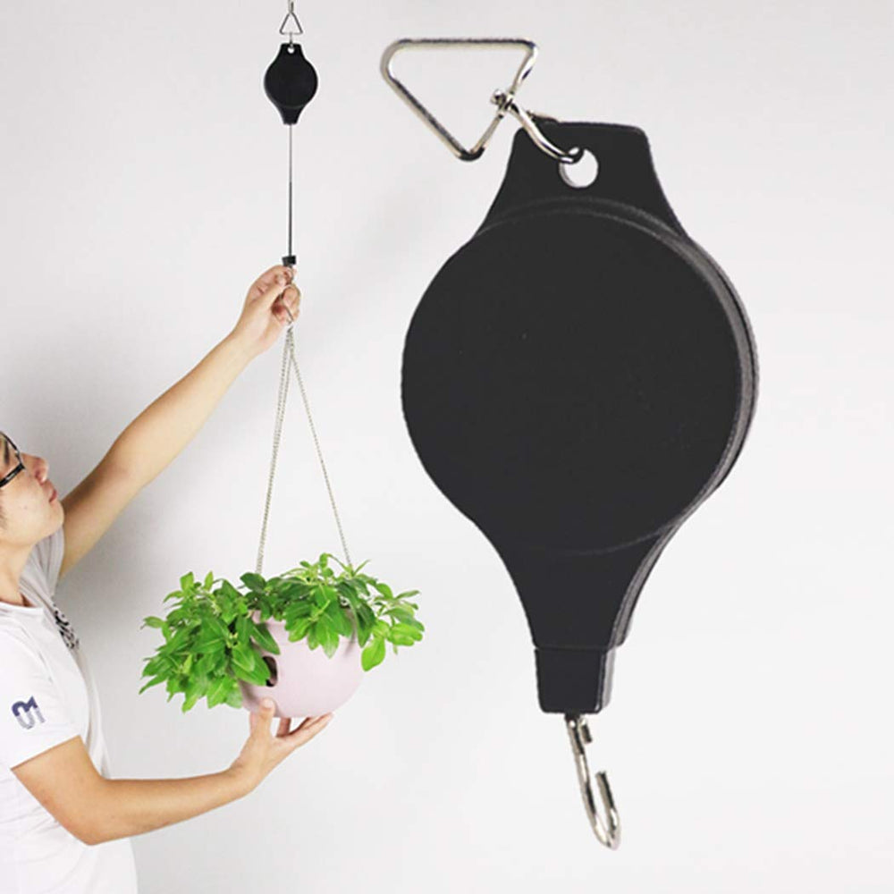 Lythor plant hanger in garden setting with flowers