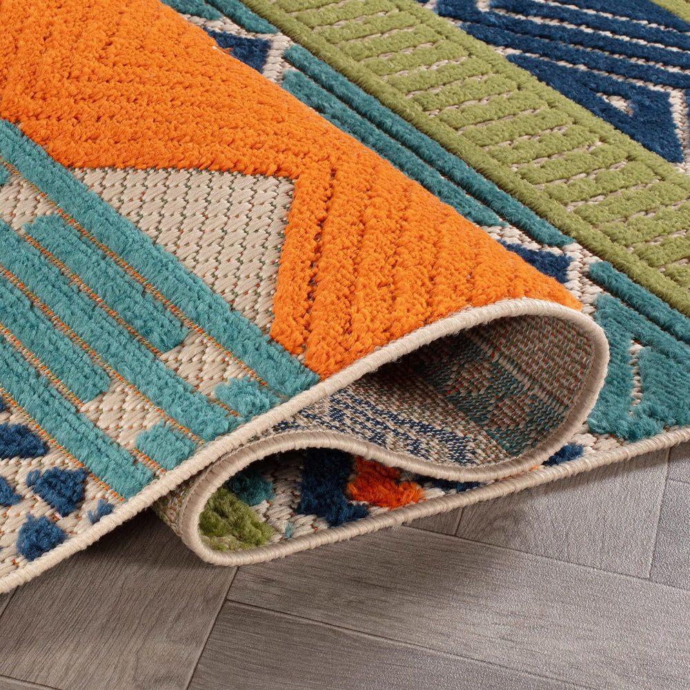 Machine washable Rugshop Marbella rug being cleaned with a hose