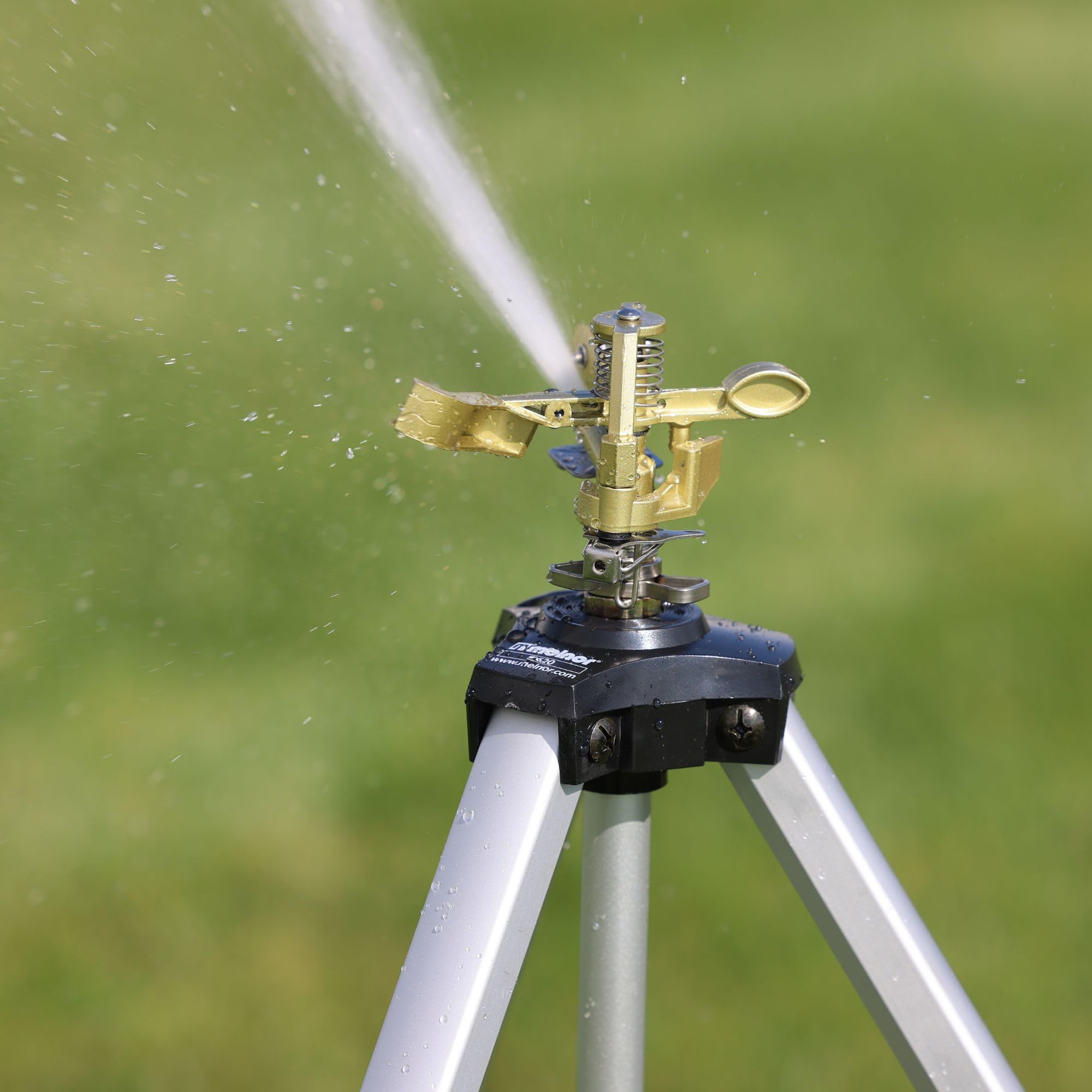 Melnor Metal Pulsating Sprinkler in use watering a lawn