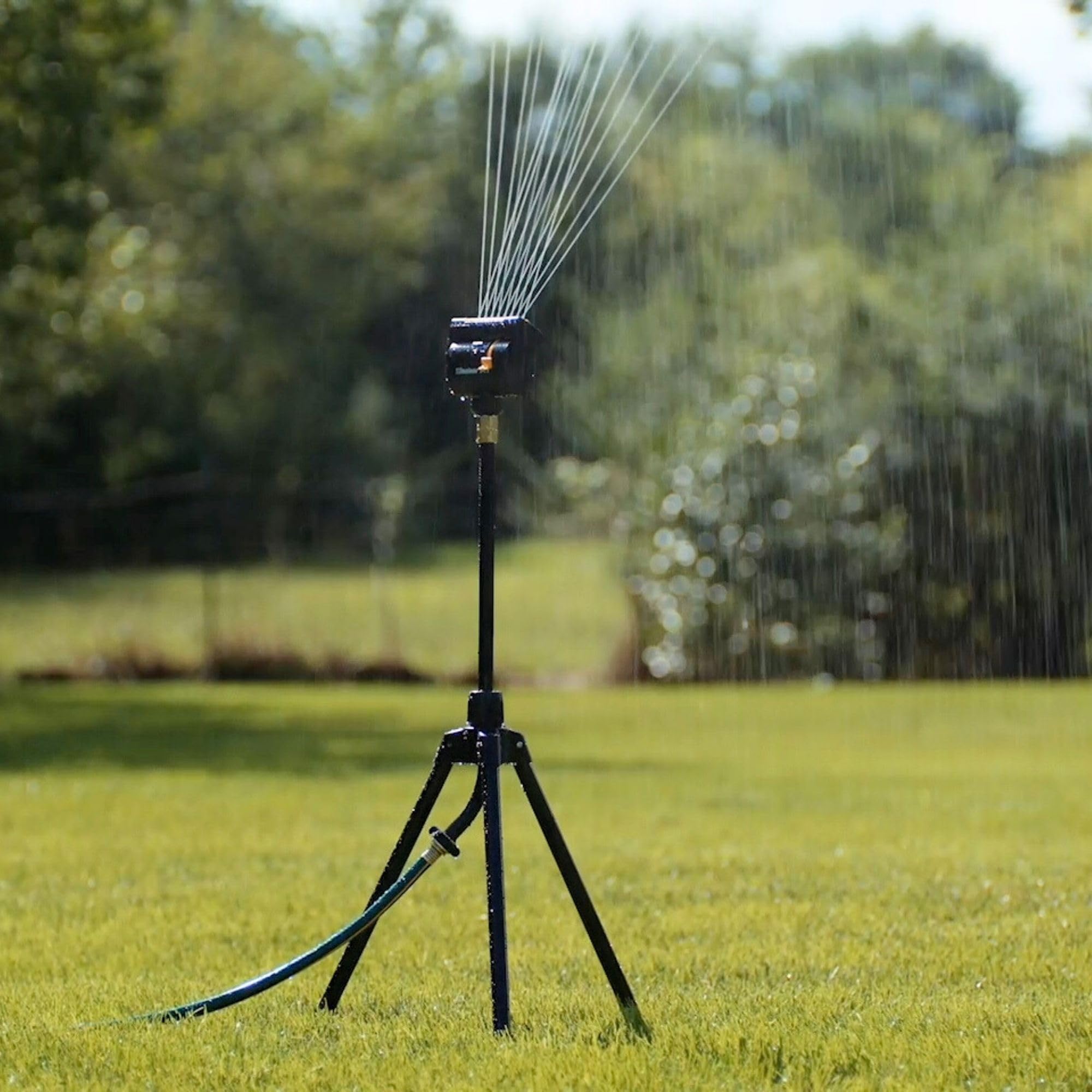 Melnor MiniMax Turbo Oscillating Sprinkler in a garden setting watering plants