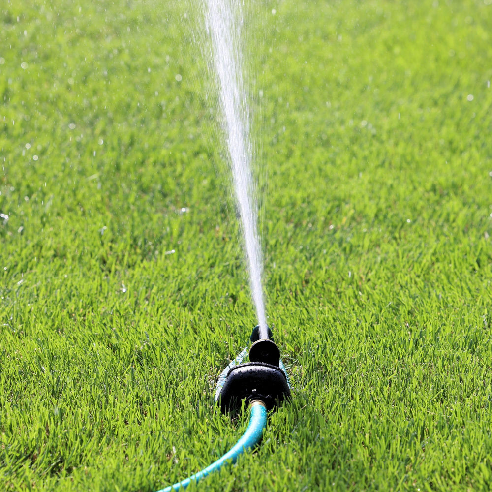 Melnor Oscillating Sprinkler close-up on a garden hose connection