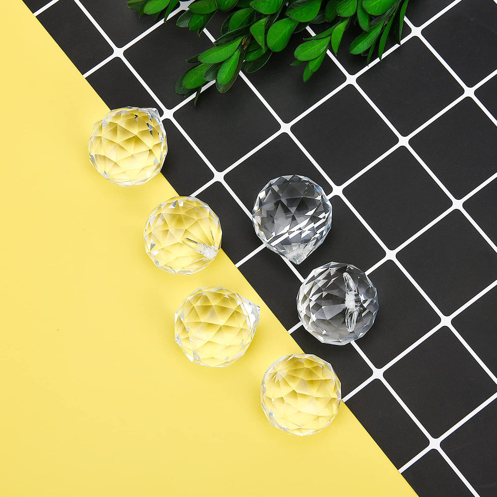 MerryNine Clear Crystal Sun Catcher Prism Balls arranged in a decorative setting