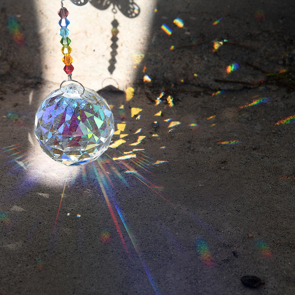 MerryNine prism balls displaying rainbows on a wall