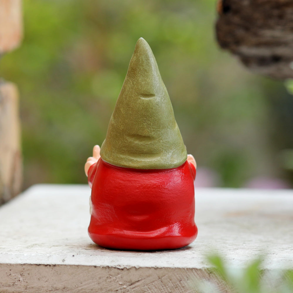Middle Finger Female Gnome displayed in a garden setting