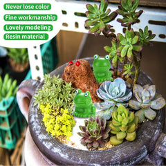 Mini frog figurines arranged in a fairy garden