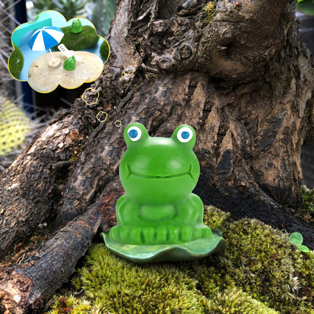 Mini frog figurines placed in a decorative fence