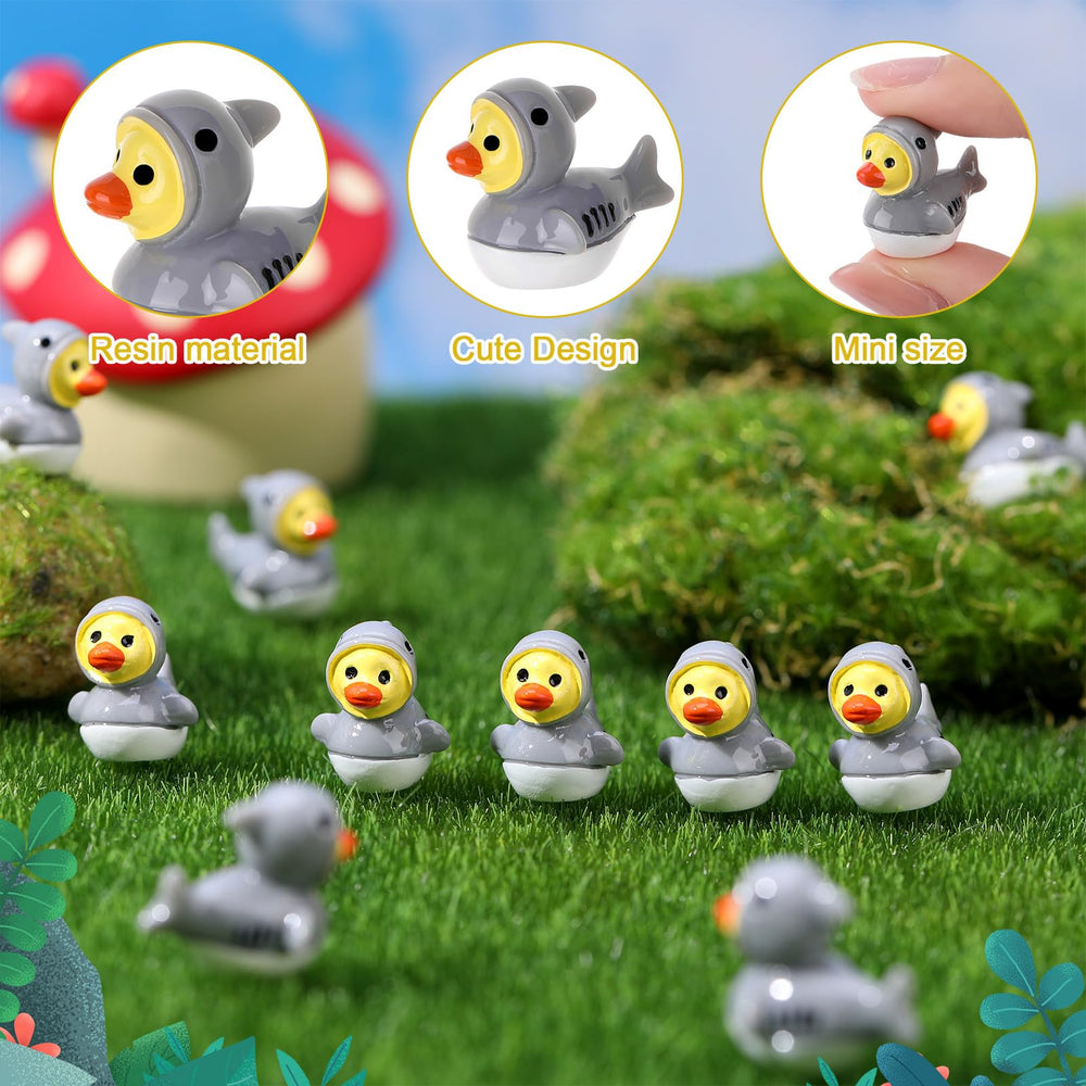 Mini shark ducks displayed in a garden setting