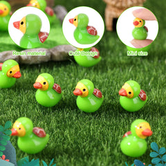 Mini turtle resin ducks displayed in a garden setting