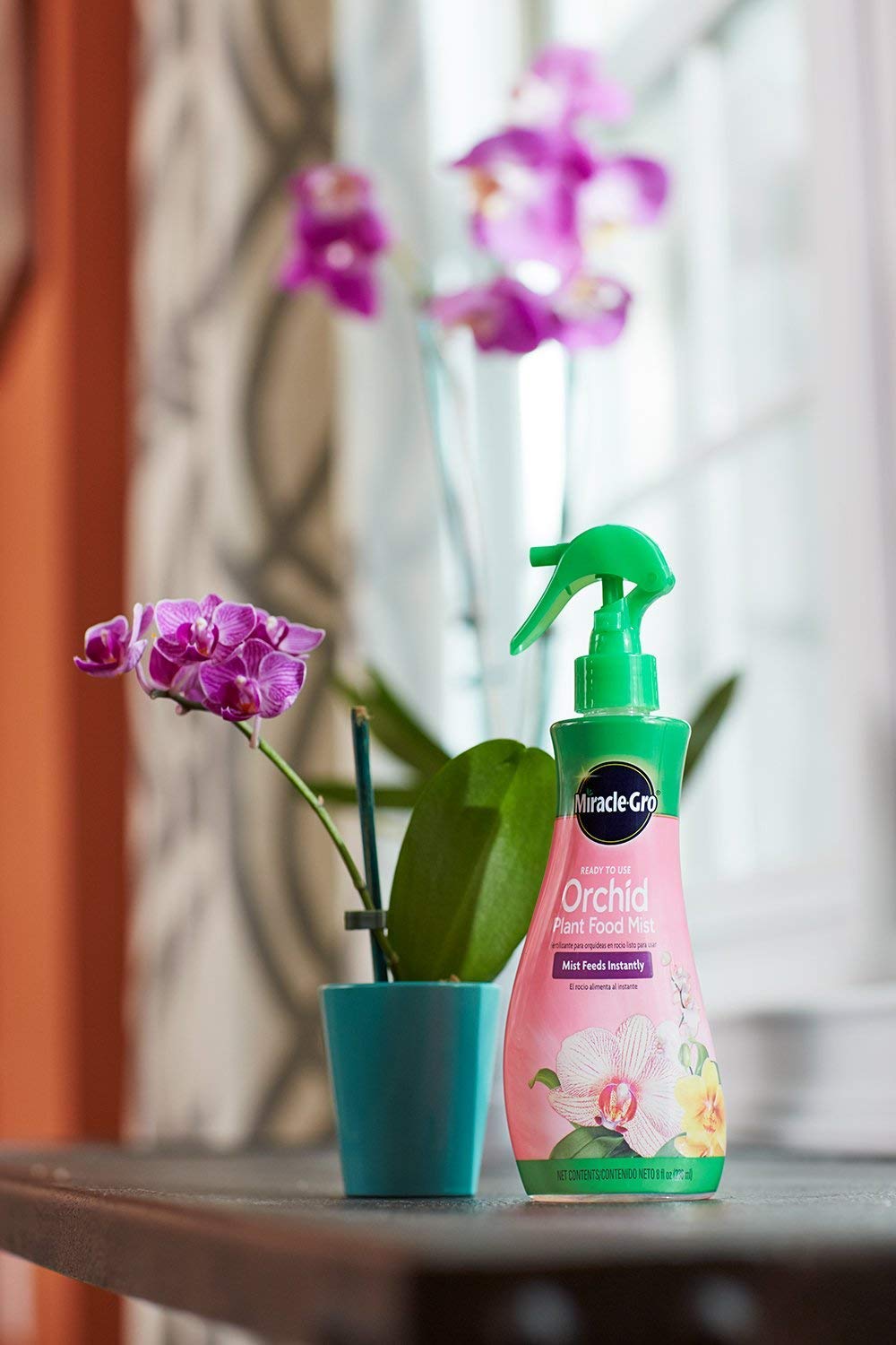 Miracle-Gro Orchid Plant Food Mist being applied to an orchid plant