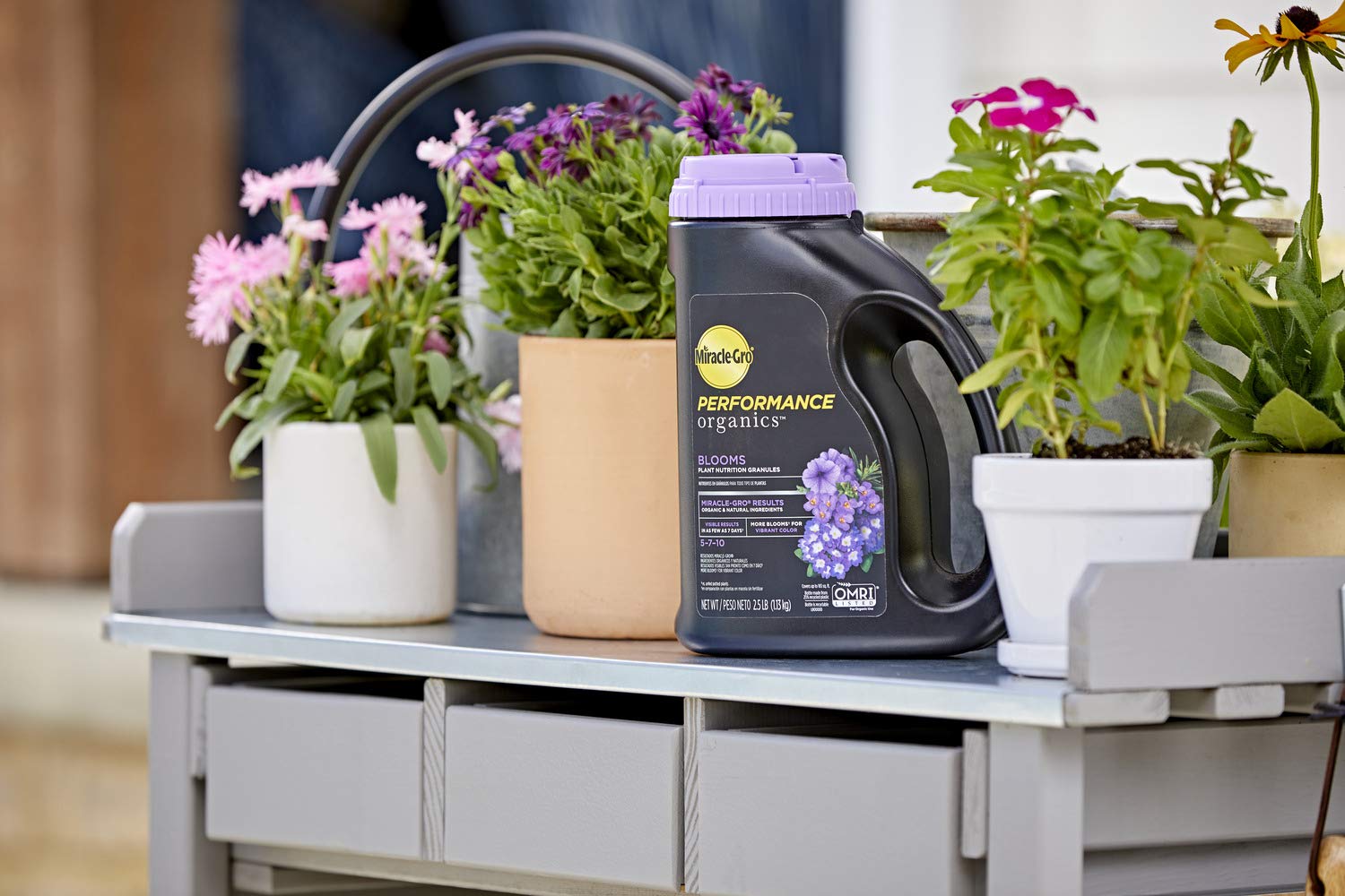 Miracle-Gro Performance Organics Granules displayed on a garden table