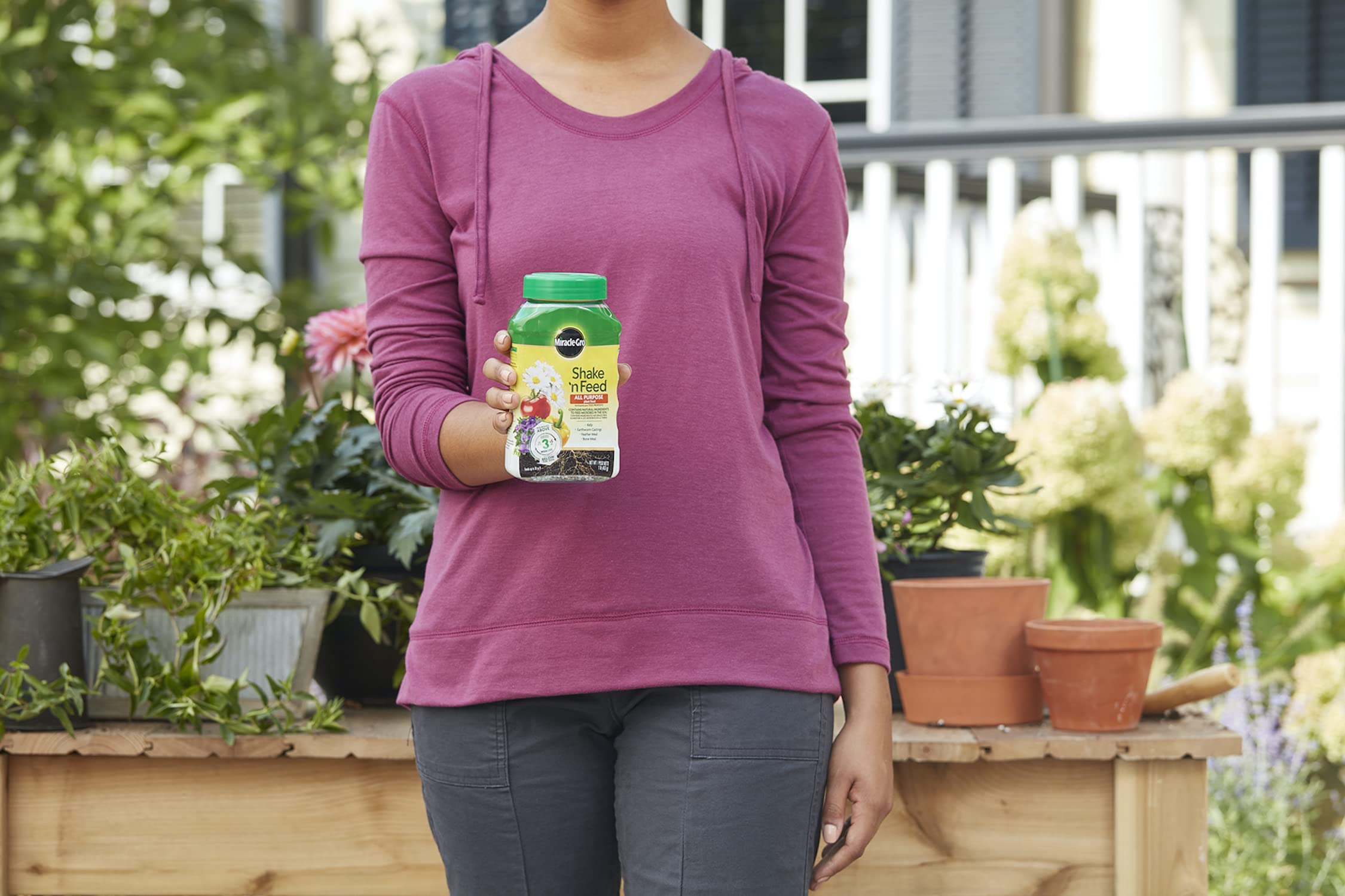 Miracle-Gro Shake 'N Feed All Purpose Plant Food in garden setting