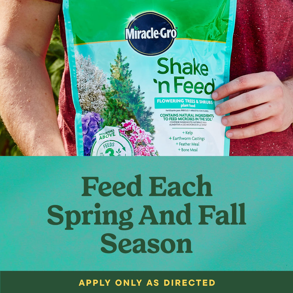 Miracle-Gro Shake 'N Feed Flowering Trees & Shrubs Plant Food in garden setting