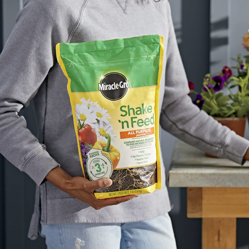 Miracle-Gro Shake 'N Feed in garden with vibrant plants