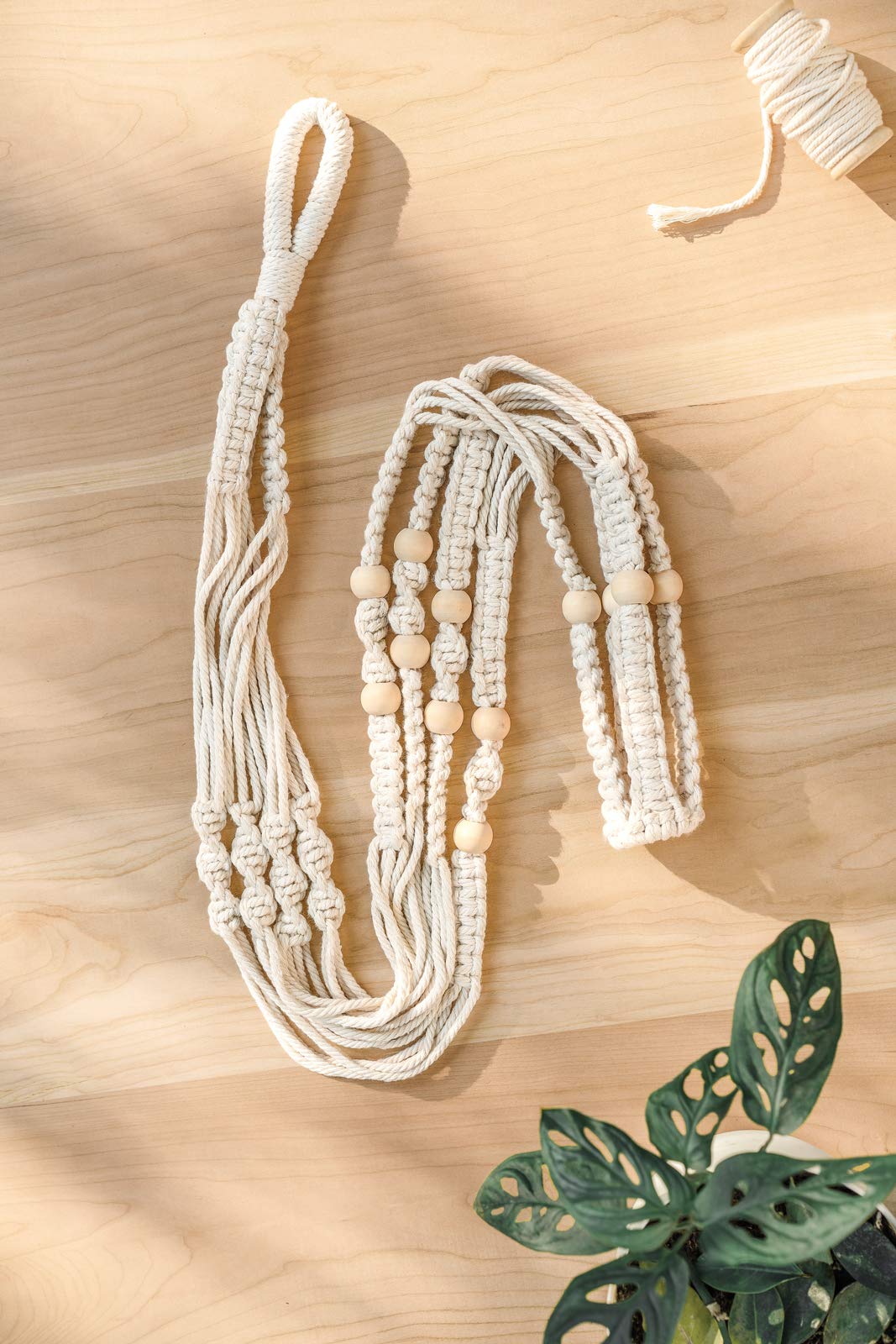 Mkono macrame plant hanger with a decorative planter