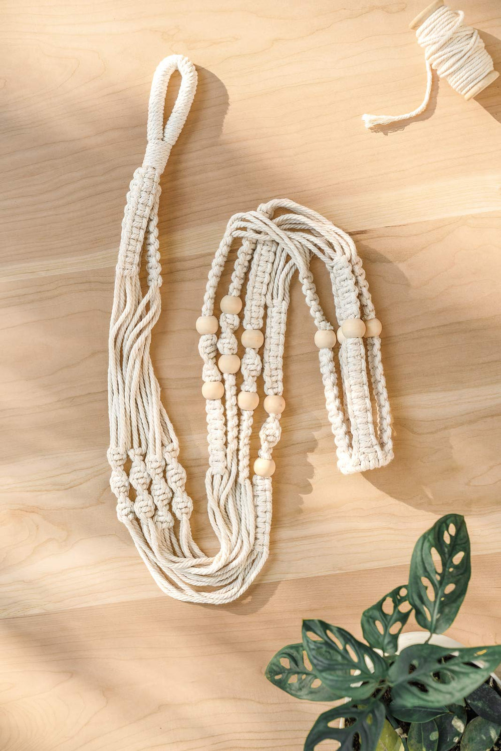 Mkono macrame plant hanger with a decorative planter