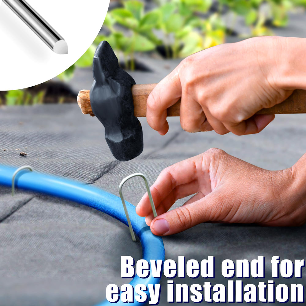 multiple garden stakes securing drip irrigation tubing