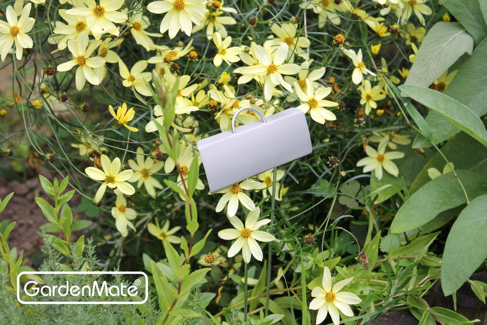 Multiple GardenMate metal plant labels inserted in various plants
