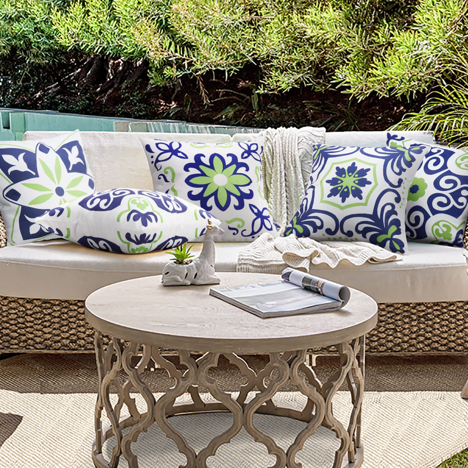 Navy blue floral printed pillow covers on a balcony