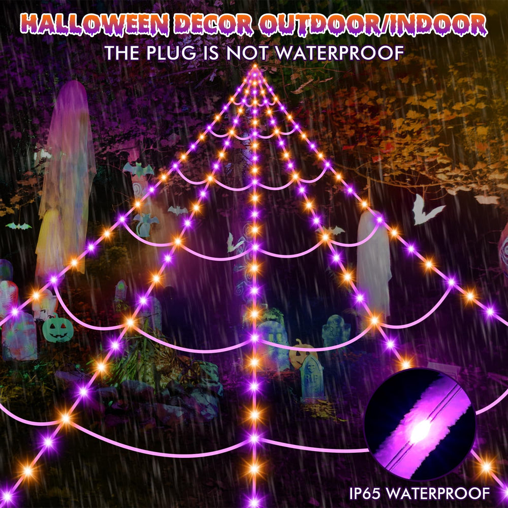 Night view of Halloween decorations with spider web lights