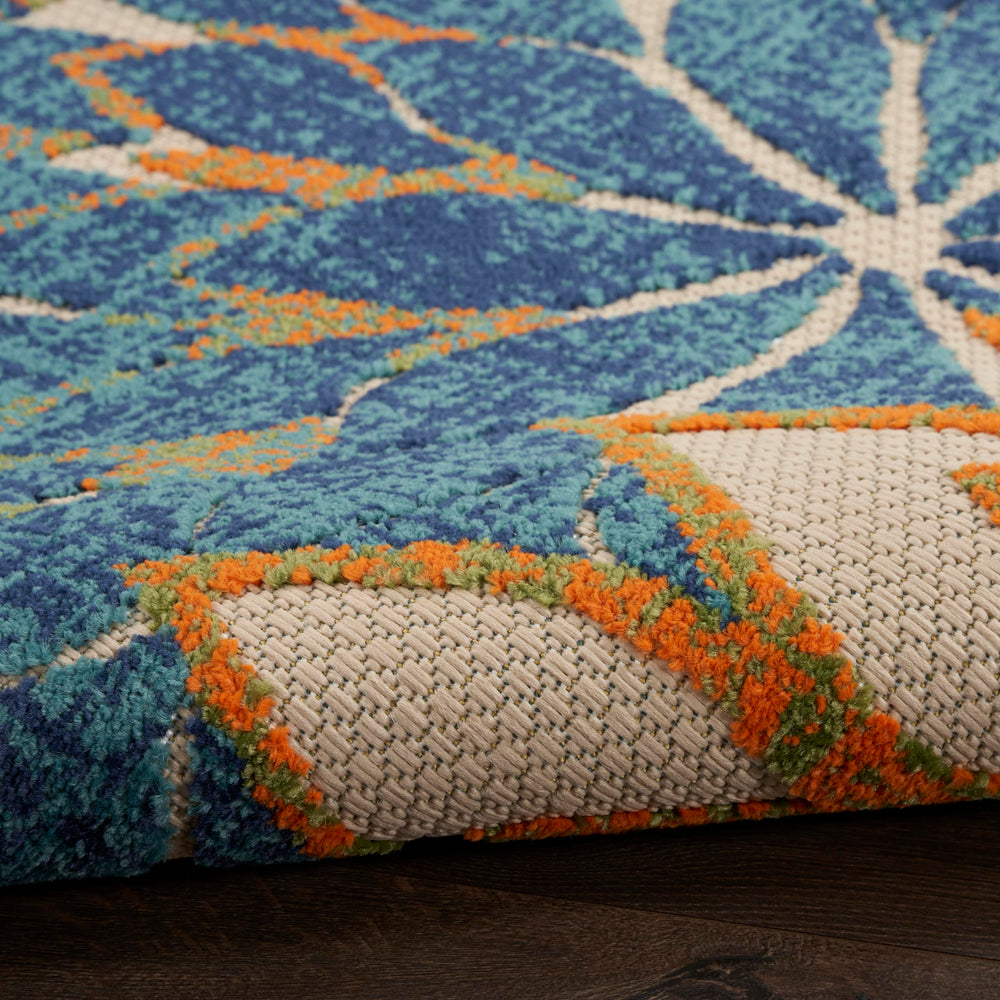 Nourison Aloha Area Rug being rinsed with a hose