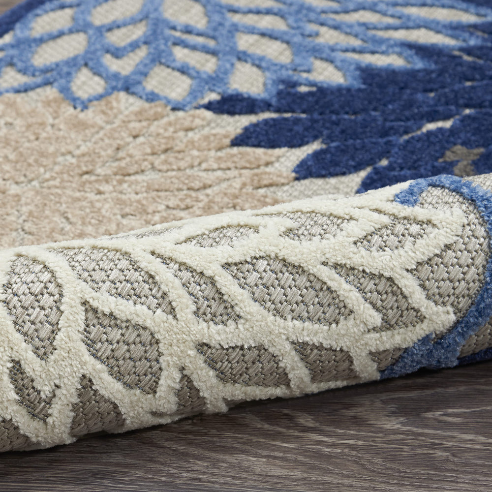 Nourison Aloha area rug in a garden setting surrounded by outdoor furniture