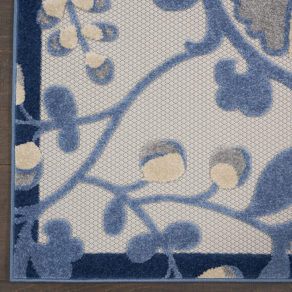 Nourison Aloha Blue Grey Area Rug in outdoor patio setting