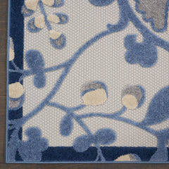 Nourison Aloha Blue Grey Area Rug in outdoor patio setting