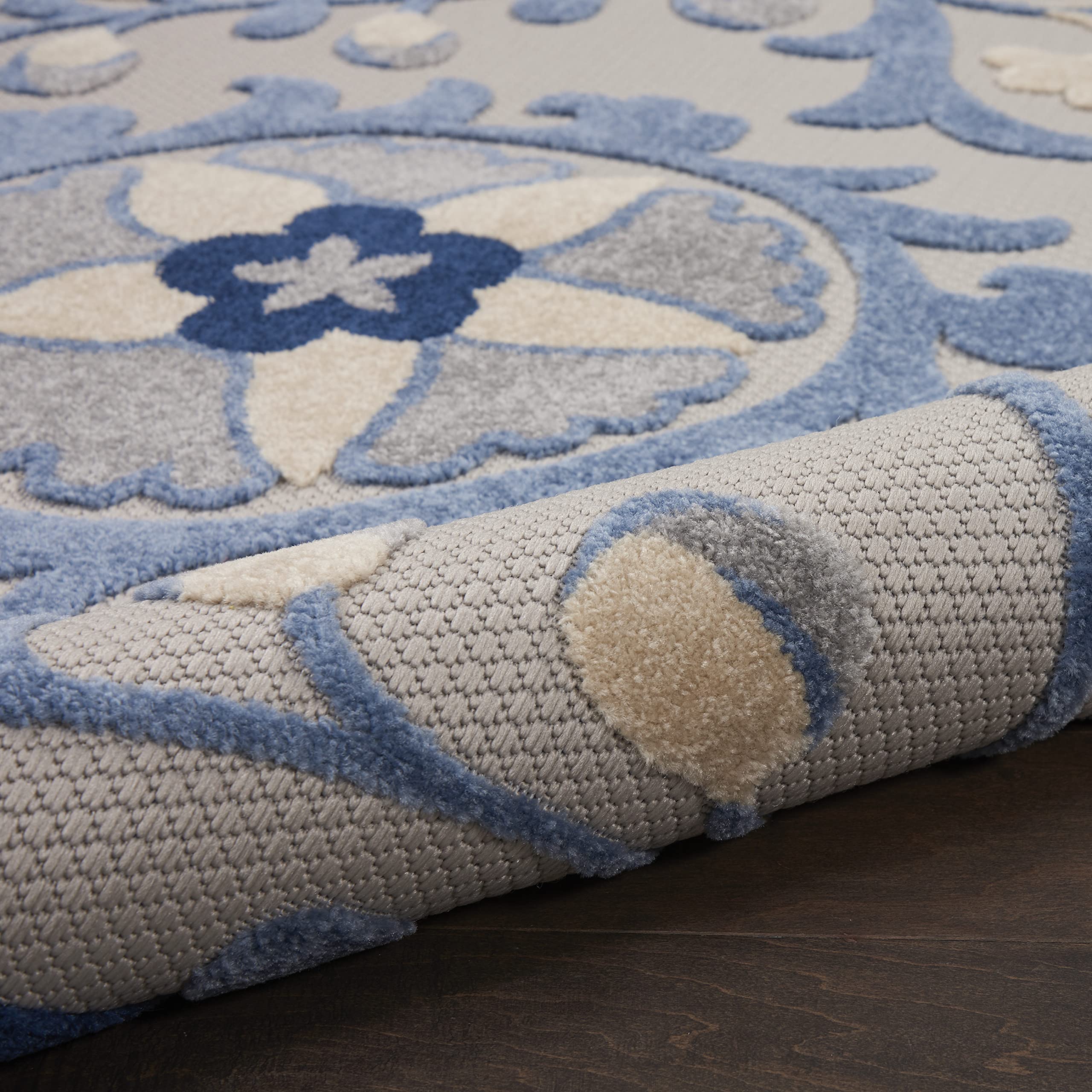 Nourison Aloha Blue Grey Area Rug rolled for storage