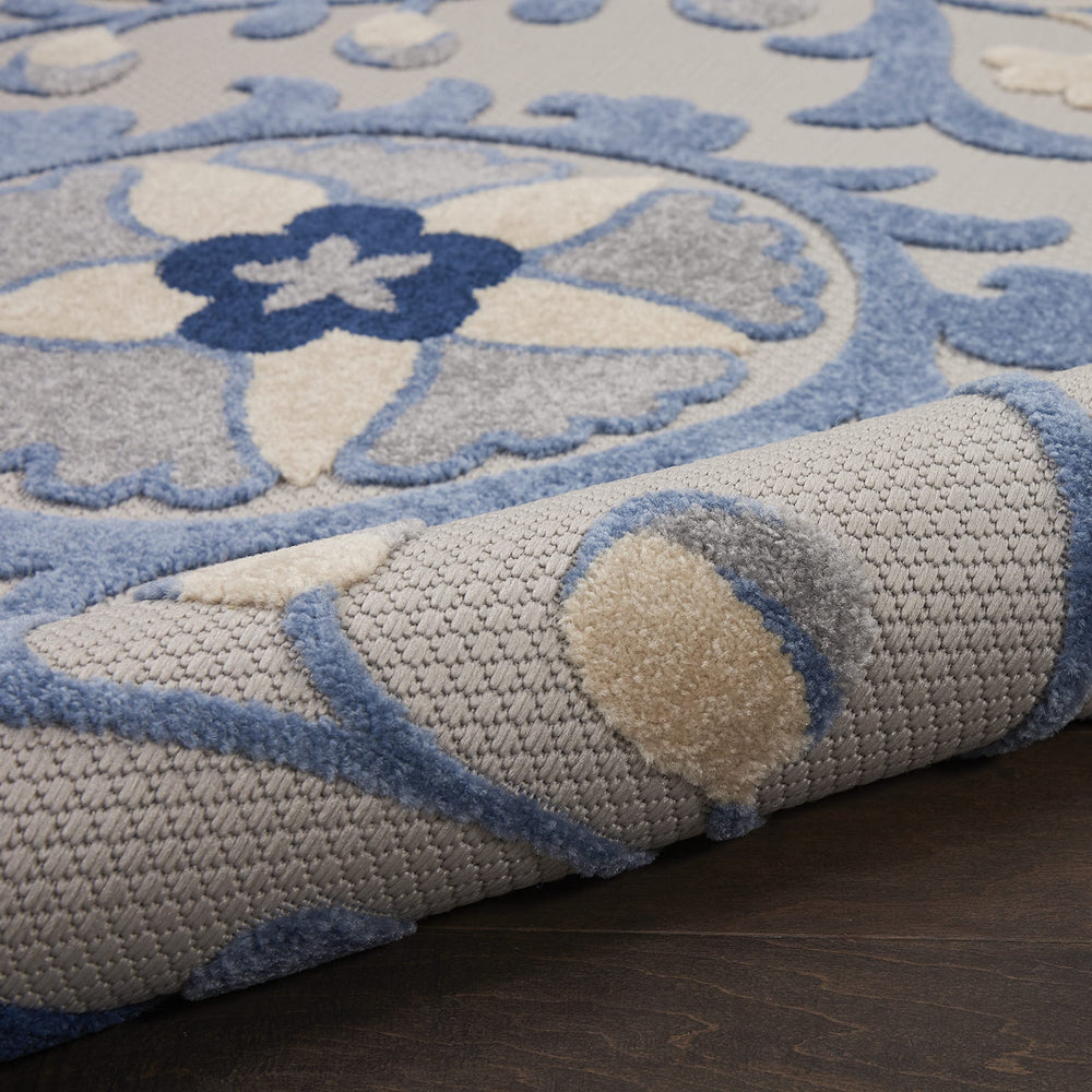 Nourison Aloha Blue Grey Area Rug rolled for storage