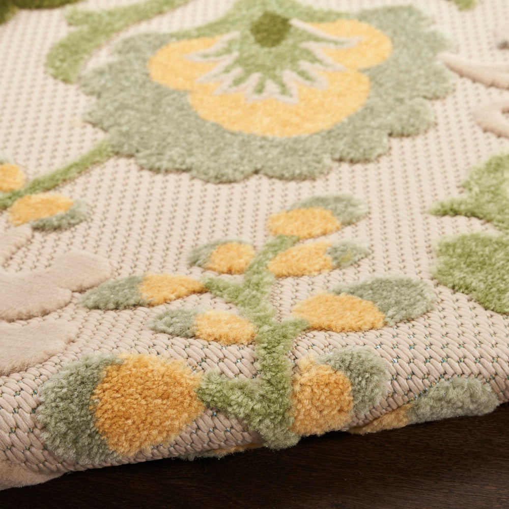 Nourison Aloha Outdoor Rug being rinsed with a hose