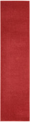 Nourison Brick Red Outdoor Runner Rug layered with another rug