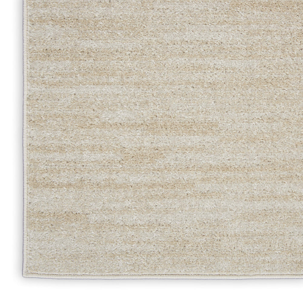 Nourison Essentials Area Rug 2' x 4' Ivory Beige layered with patterned rugs