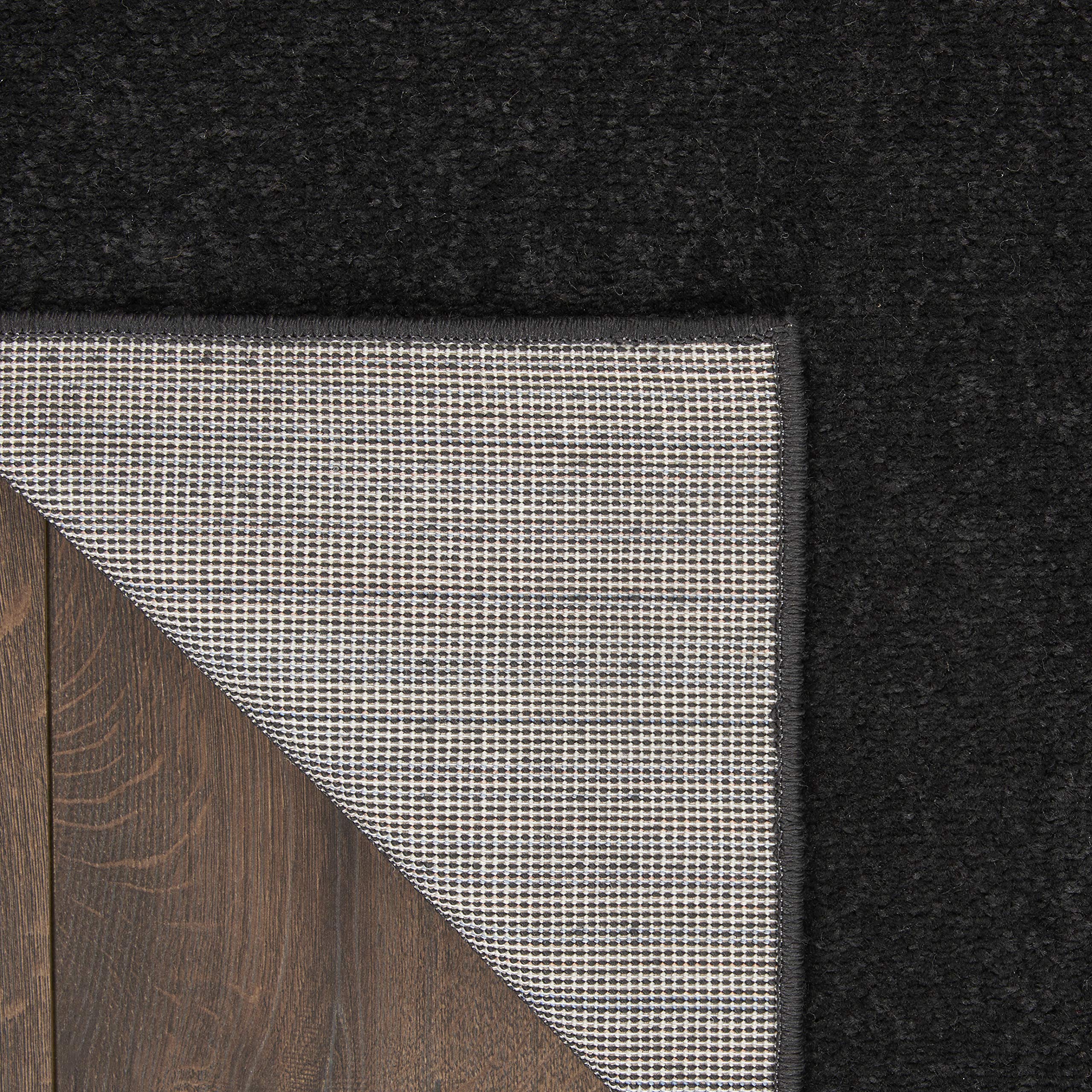 Nourison Essentials Black Runner Rug in an outdoor patio setting